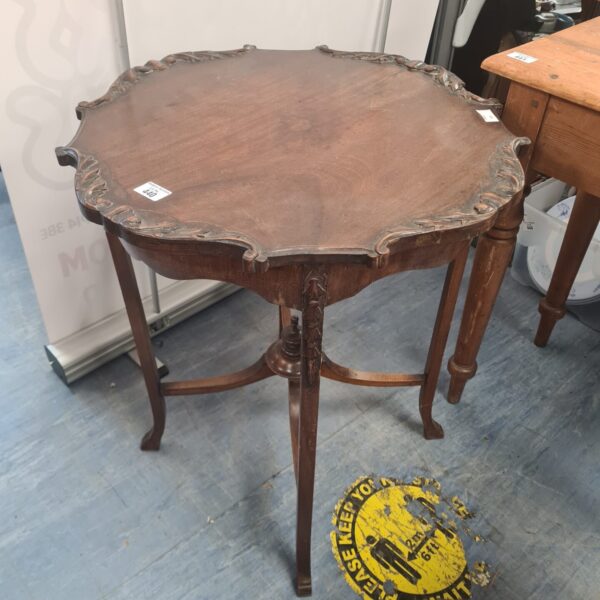 Antique mahogany lamp table with carved legs and circular top.