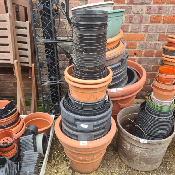 Mixed lot of colourful plastic garden pots for plants.