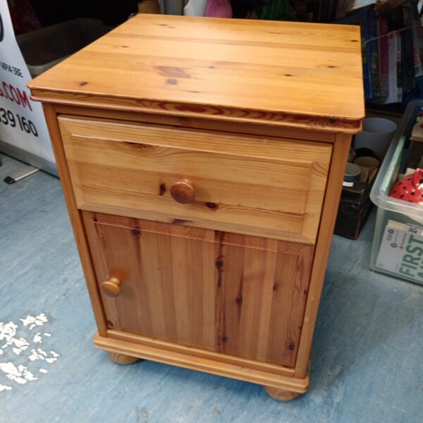 Vintage pine bedside cabinet with a single drawer.