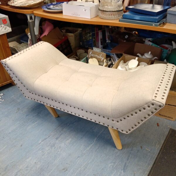 Modern grey fabric chaise lounge bench with wooden legs.
