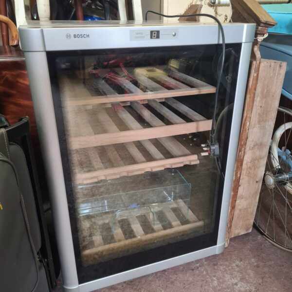 Front view of a used Bosch wine cooler with multiple shelves.
