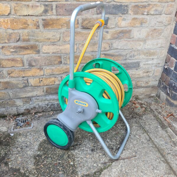 Vintage Hozelock garden hose reel in green plastic.