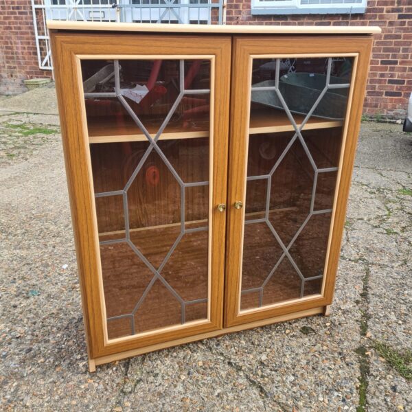Vintage leaded glass display cabinet with mahogany finish.