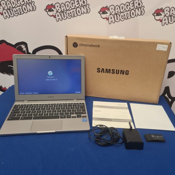 Boxed Samsung Chromebook laptop with screen displaying login.