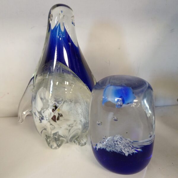 Pair of Murano glass paperweights featuring a penguin and dolphin.