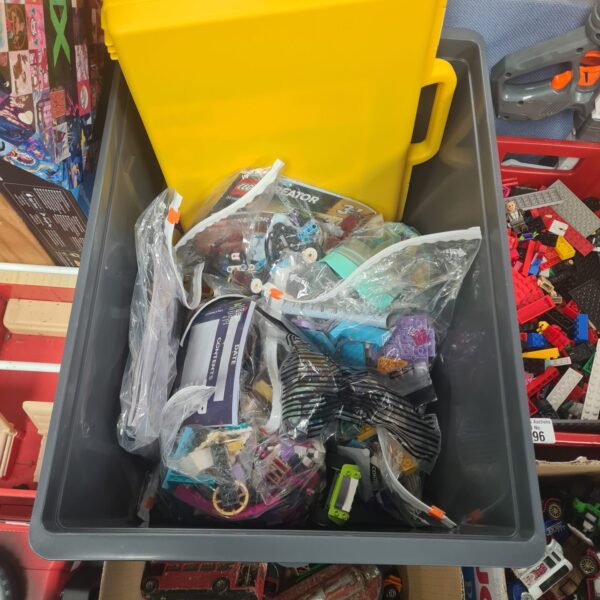 Plastic storage box filled with a large mixed Lego lot.