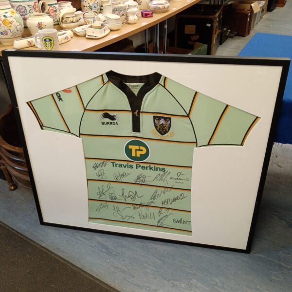 Framed Northampton Saints rugby shirt signed by the team.