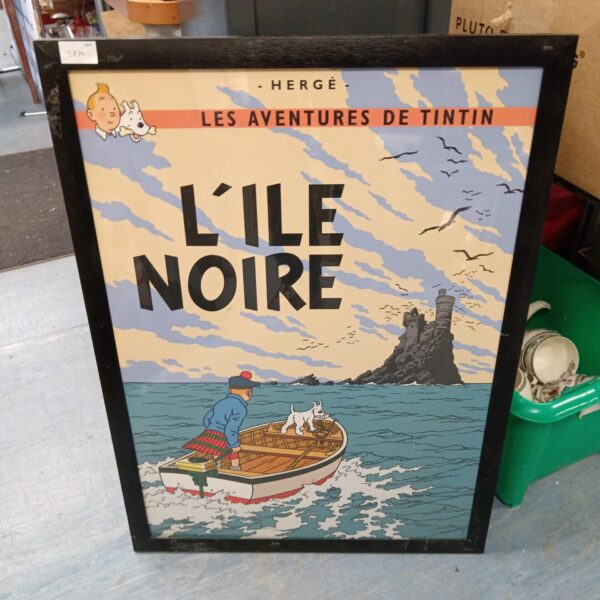 Vintage French Tintin L'Ile Noire poster in a frame.