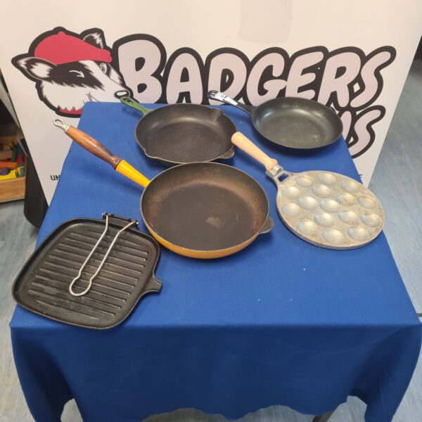 Selection of vintage cast iron pans for cooking and collecting.