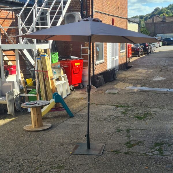 Large garden parasol with a sturdy cast iron base for outdoor shade.