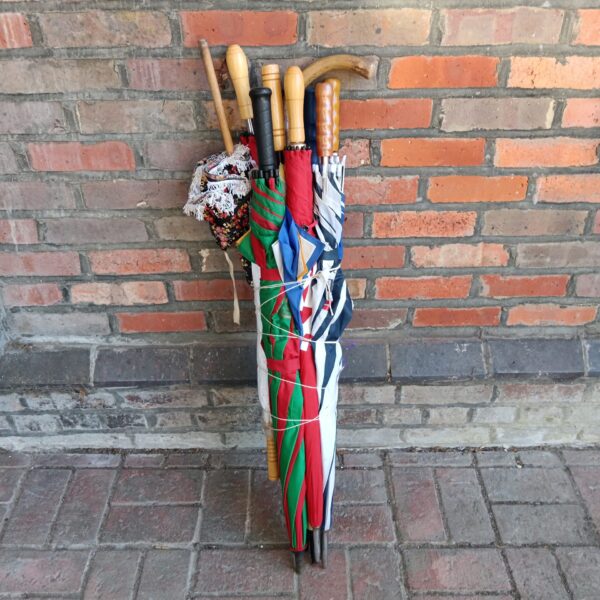 Large bundle of vintage and modern umbrellas for collectors.