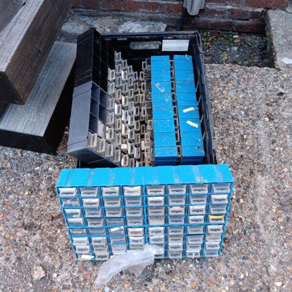 Four sets of plastic workshop drawers for tool and parts storage.