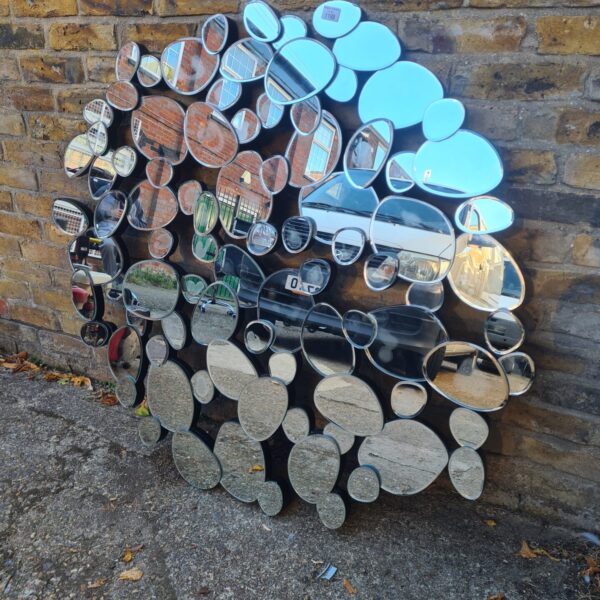 Large pebble mirror with mosaic style arrangement.