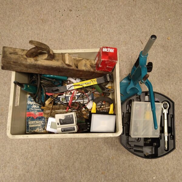 Tool and hardware lot with hydraulic jack and wood plane inside a box.
