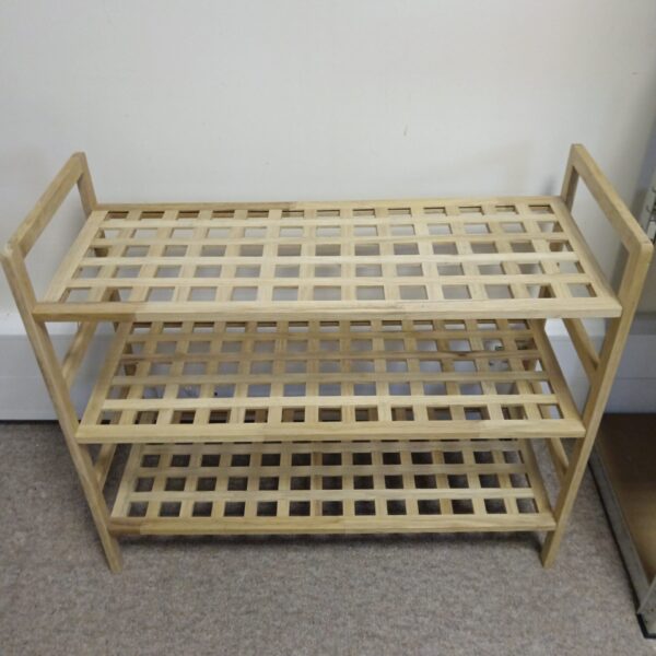 Three-tier wooden shoe rack with lattice shelves for shoe storage.