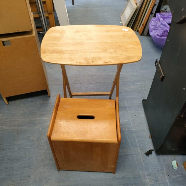 Vintage folding wooden table with storage stool for small spaces.