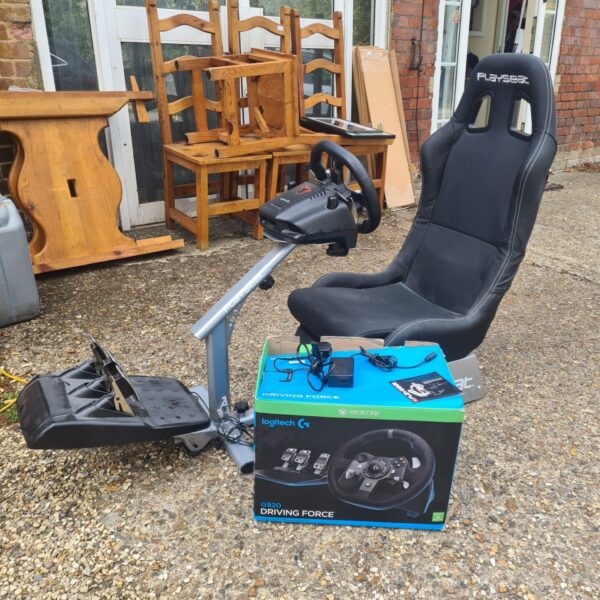 Logitech G920 racing wheel and Playseat setup for Xbox One gaming.
