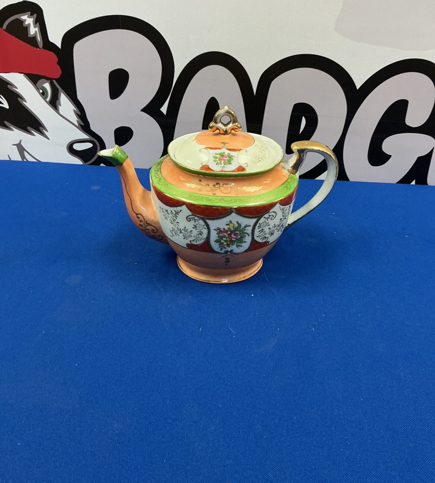 Antique Samurai teapot with intricate Japanese porcelain design.