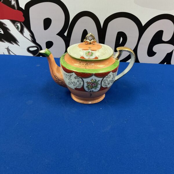 Antique Samurai teapot with intricate Japanese porcelain design.