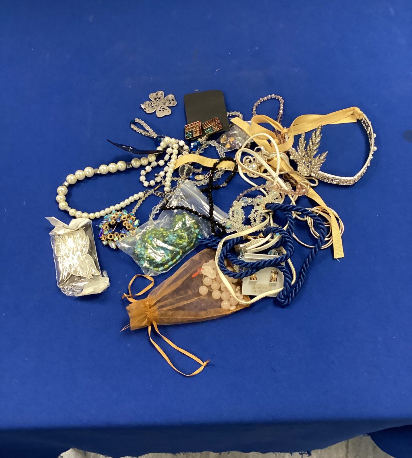 Mixed lot of vintage and costume jewellery in a drawstring bag.