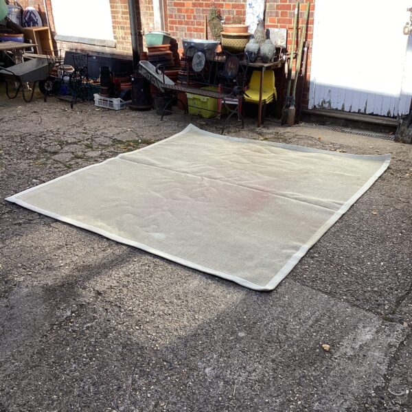 Large cream Crucial Trading rug for living room comfort.