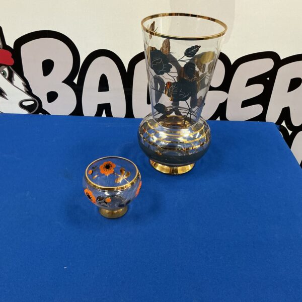 Elegant decorative glass vases with rose design and gold leaf rim.