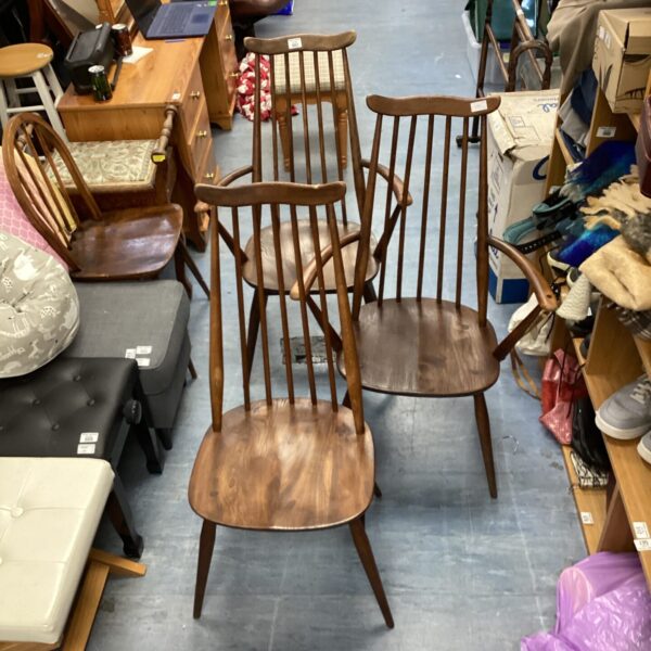 Lot of three vintage Ercol stick back chairs in warm beech wood.
