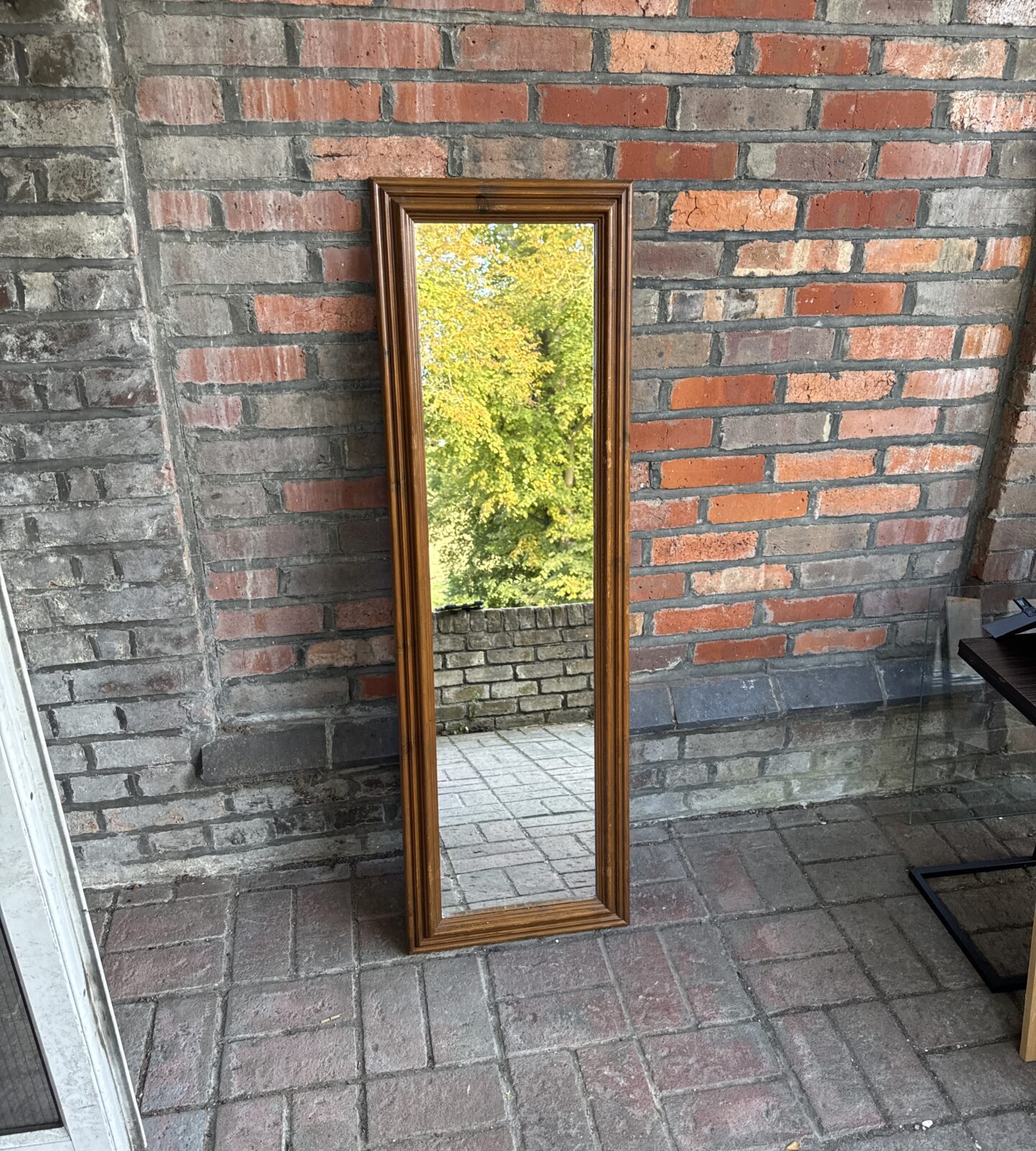 Vintage full length mirror with a warm wood frame.
