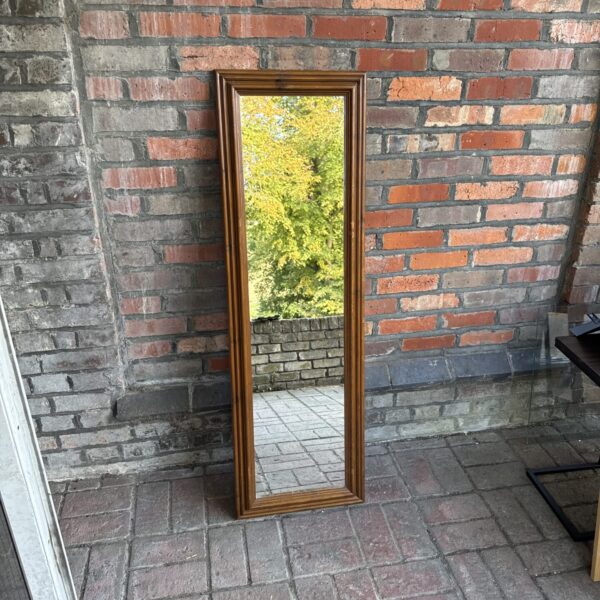 Vintage full length mirror with a warm wood frame.