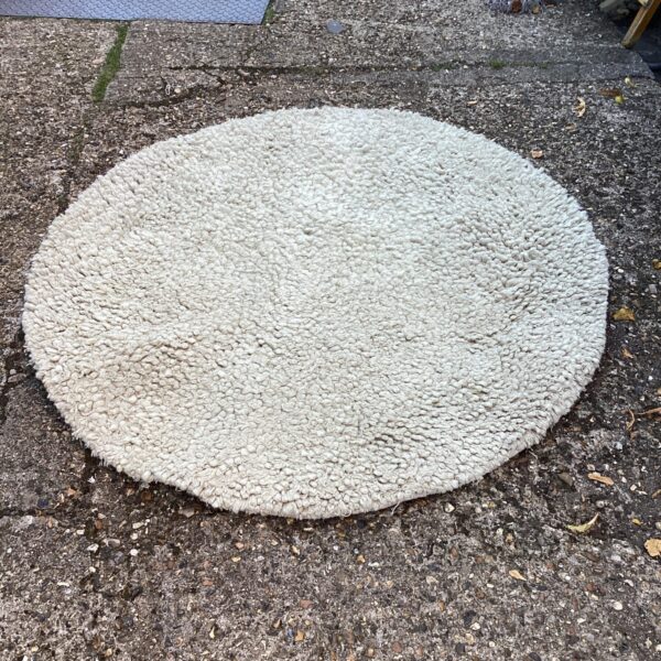Soft grey round shagpile rug for comfortable home decor.
