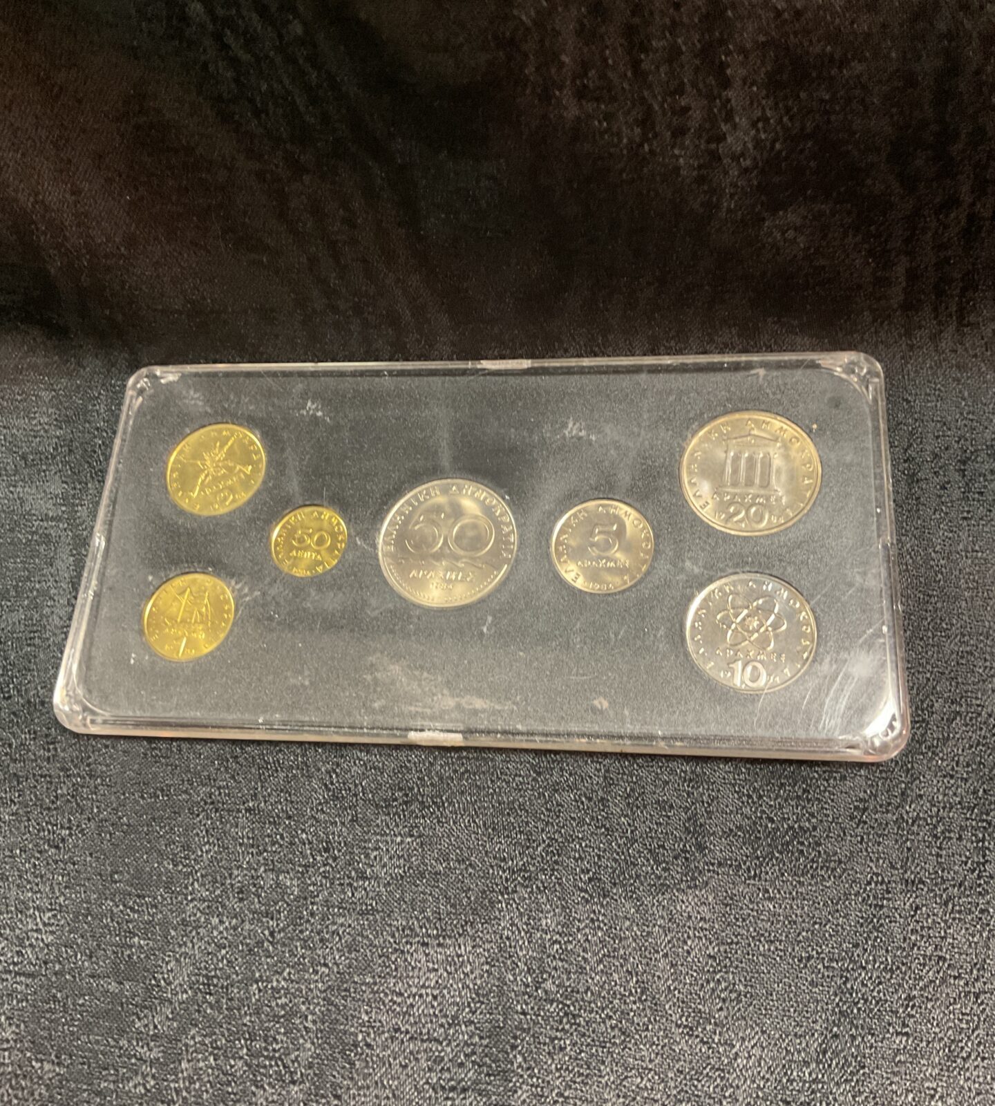 Side view of the 1984 Hellas coin collection in its case.