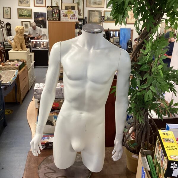 Vintage male manikin torso for display and clothing presentation.