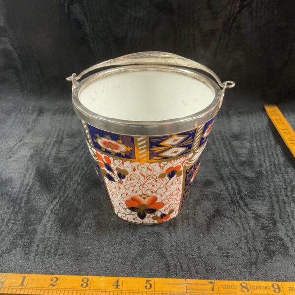 Antique Davenport ice bucket with floral design and silver plate handles.