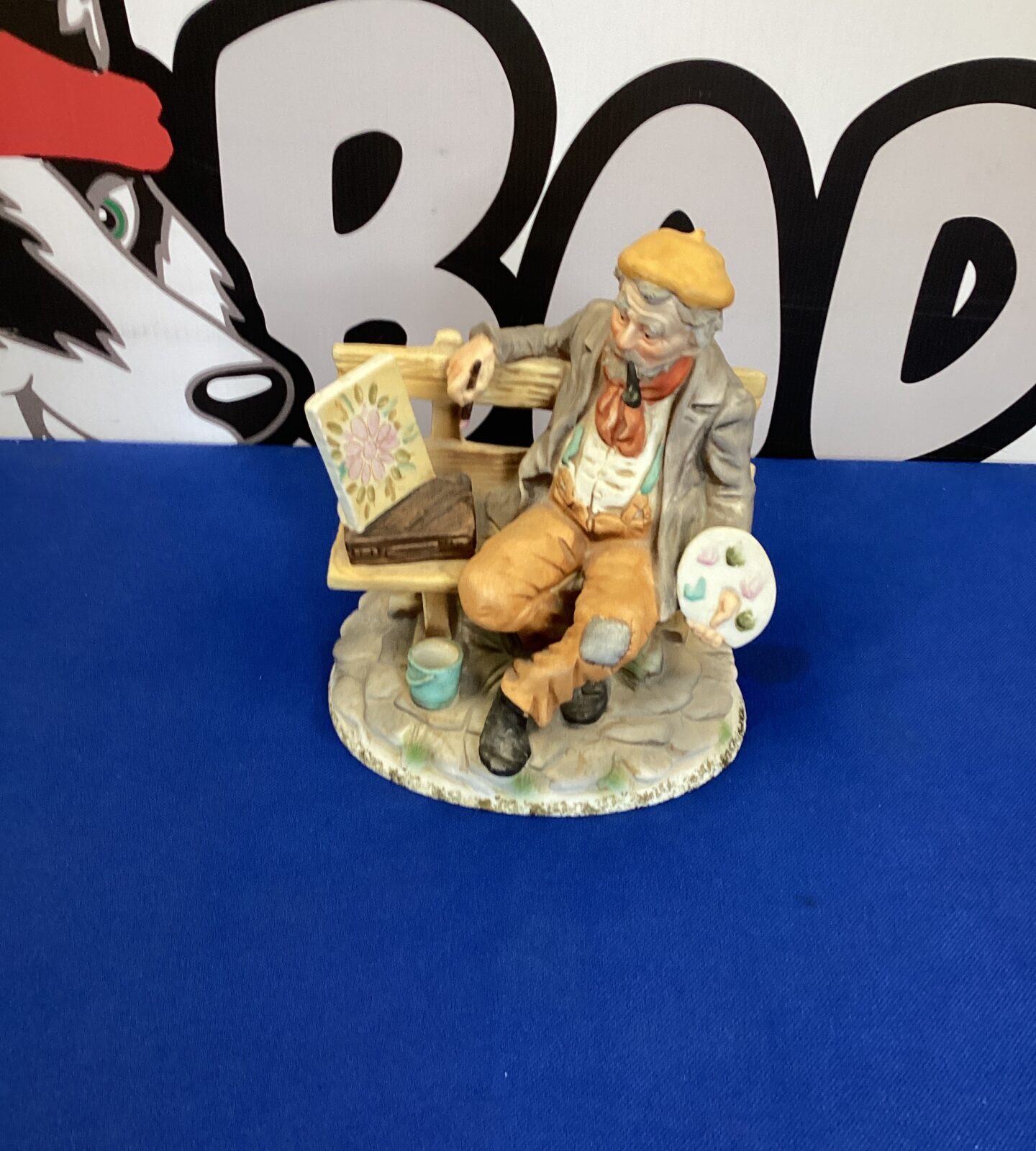 Bisque porcelain artist on bench marked MR on base