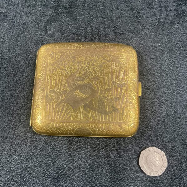 Antique silver gilt cigarette case with crane and pagoda design.