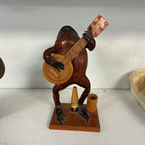 Vintage taxidermy frog playing guitar, unique folk art curio.