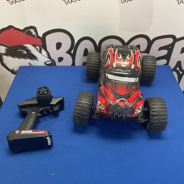Red and black Himoto Mt-300 RC monster truck with remote control.