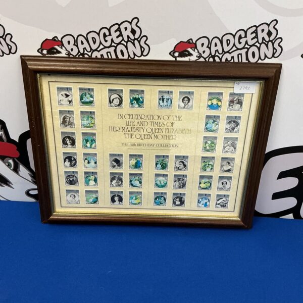 Framed collection of vintage Queen Elizabeth commemorative stamps for collectors.