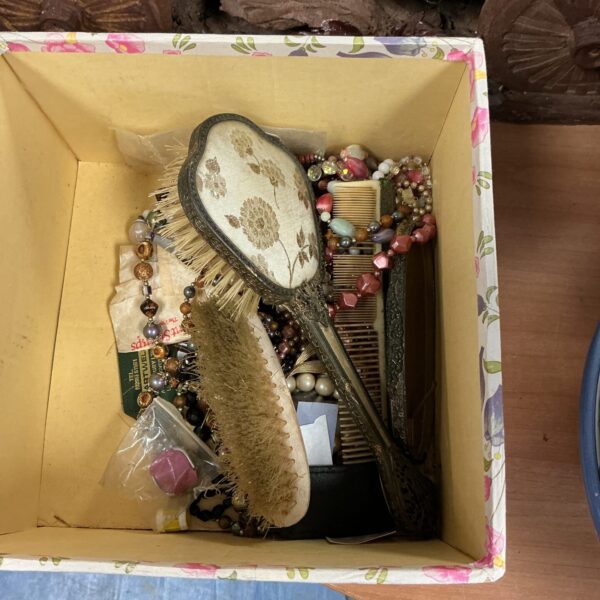 Vintage mixed jewellery and dressing table set with necklaces and combs.