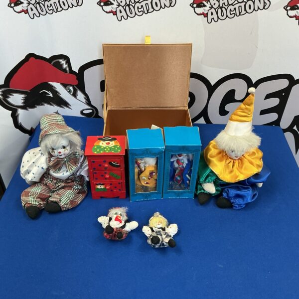 Vintage clown toy collection with colourful costumes and porcelain faces.