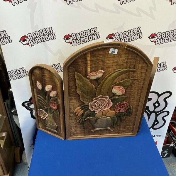 Antique carved wood folding fire screen with floral details.