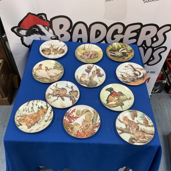 Collection of vintage porcelain plates with animal designs.