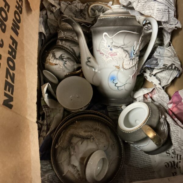 Vintage porcelain coffee set with dragon design.