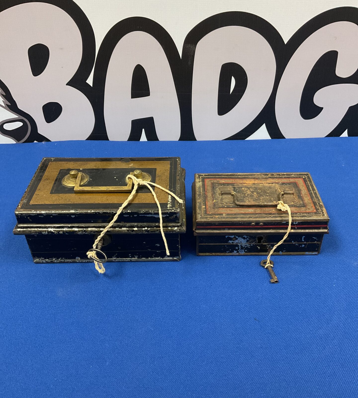 Two vintage lockable tin money boxes with keys