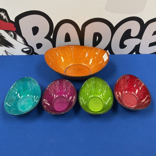 Set of colourful glass dessert dishes on a patterned background.
