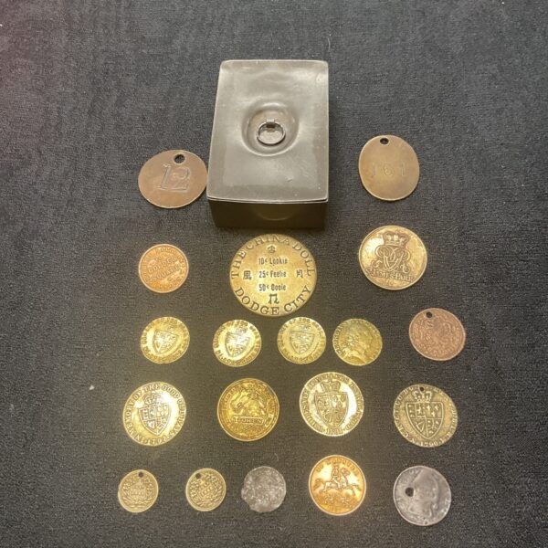 Antique pewter box with a collection of gaming tokens /coins Inc dodge city the china doll token and Cumberland jack token