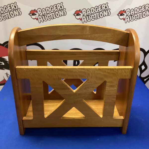 Vintage wooden magazine rack for storing reading materials.