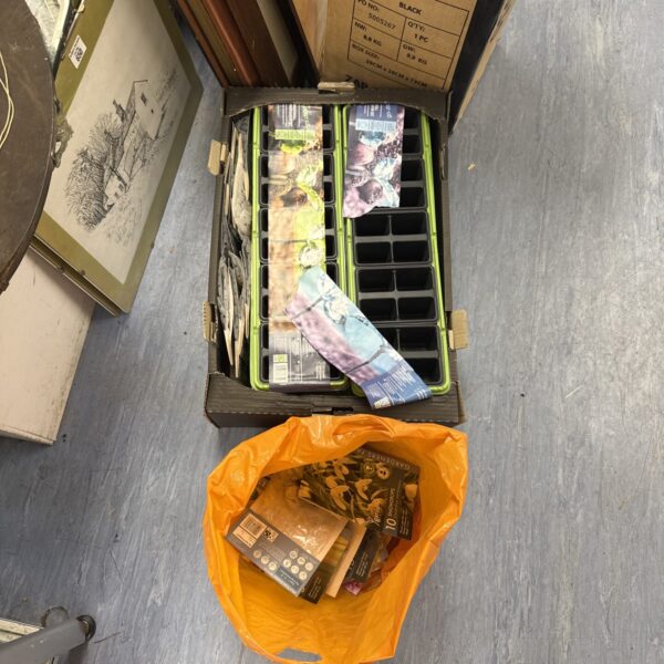 Box of seedling trays with a bag of assorted seeds