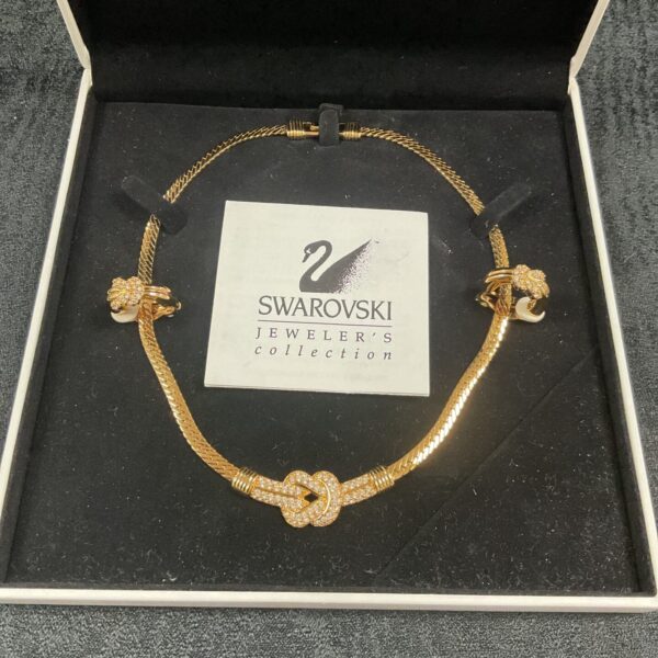 Gold tone Swarovski necklace with heart pendants.