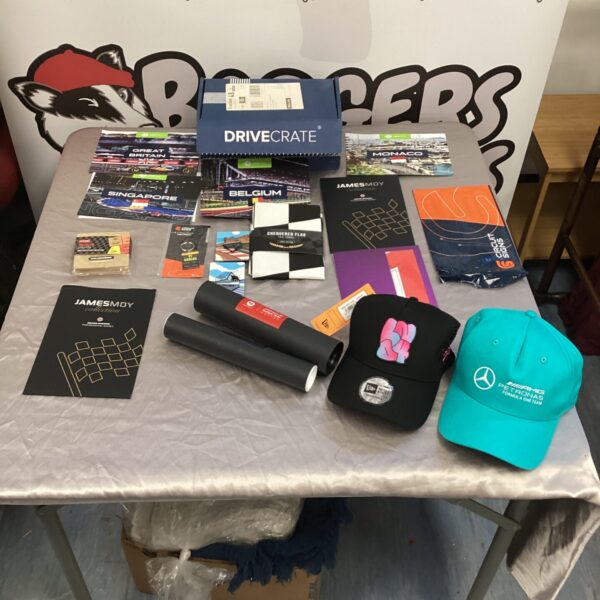 Drivecrate F1 subscription box with Formula 1 merchandise and AMC cap.